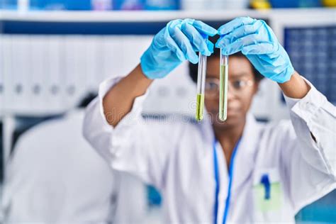 African American Man And Woman Scientists Holding Test Tubes At