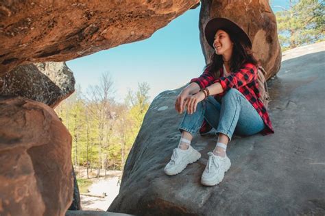 Premium Photo Happy Woman Hiker Sitting At The Rock