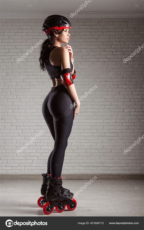 Slender Woman In Sports Clothes On Roller Skates Against The Wall Stock