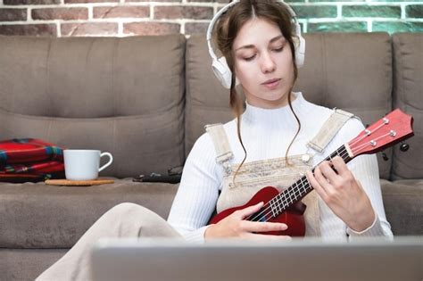 Premium Photo Caucasian Girl Listens To Music Through Headphones