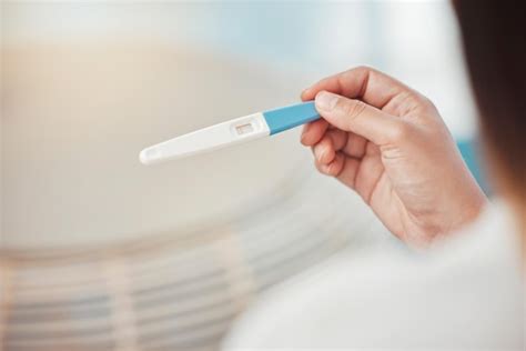 Premium Photo Woman Hands And Pregnancy Test With Negative Results