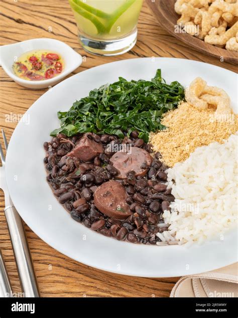 Typical Brazilian Feijoada With Rice Pepper Farofa Kale Caipirinha