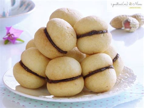 A Pile Of Cookies Sitting On Top Of A White Plate Next To A Pink Flower