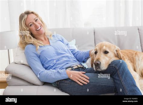 Smiling Blonde Woman Petting Her Golden Retriever Stock Photo Alamy