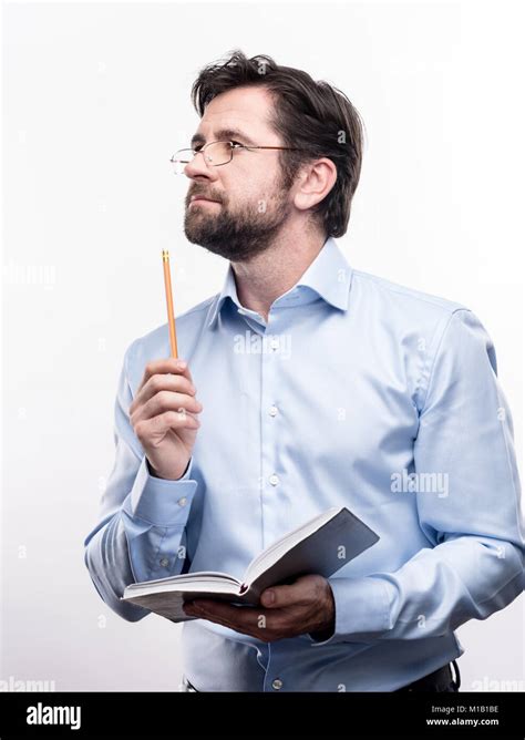 Pleasant Professor Thinking What To Write In Notebook Stock Photo Alamy