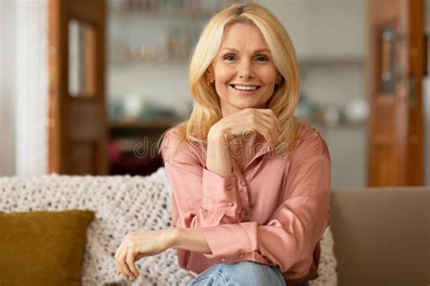 Happy Blonde Mature Lady Smiling To Camera Sitting At Home Stock Image Image Of Aged House