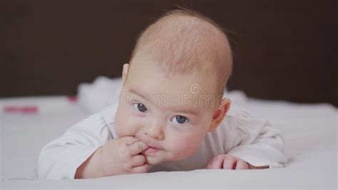 Portrait Of A Nice Newborn Baby Lying On His Stomach Looking