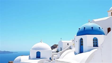 Santorini White Buildings With Blue Domes Overlooking The Sea Premium