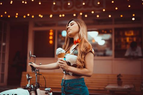 Young Woman Holding Ice Cream in front of a Building · Free Stock Photo