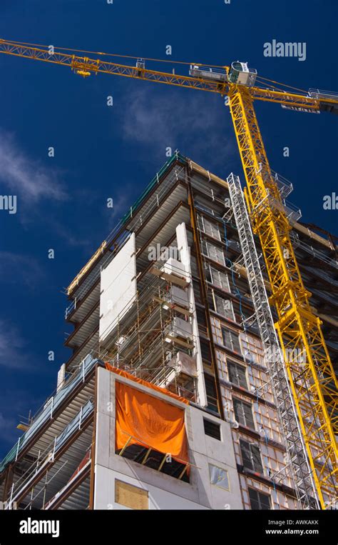 A High Rise Building Under Construction With Crane In Central