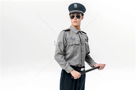 The Security Guard Is Holding A Baton Picture And Hd Photos Free