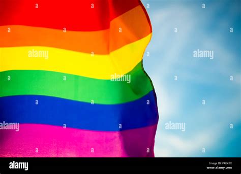Backlit Gay Pride Rainbow Flag Flutters In The Breeze With Lens Flare Stock Photo Alamy