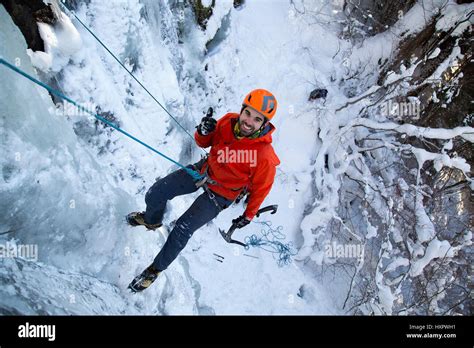 An Ice Climber Descends A Frozen Waterfall On Mount Hood Oregon