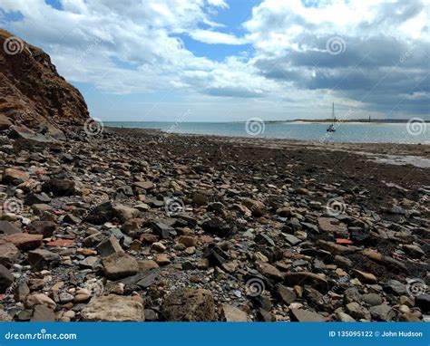 Beach Scene At Lindisfarne Uk With Exposed Rocks On The Beach Stock