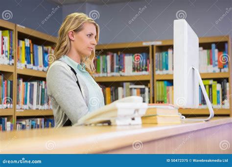 Pretty Librarian Working In The Library Stock Photography