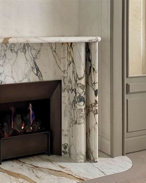 An Elegant Fireplace With Marble Surround In A Living Room