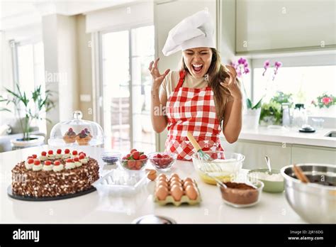 Beautiful Young Brunette Pastry Chef Woman Cooking Pastries At The Kitchen Celebrating Mad And