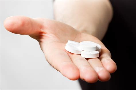 Premium Photo Man Holding Pills In Hand