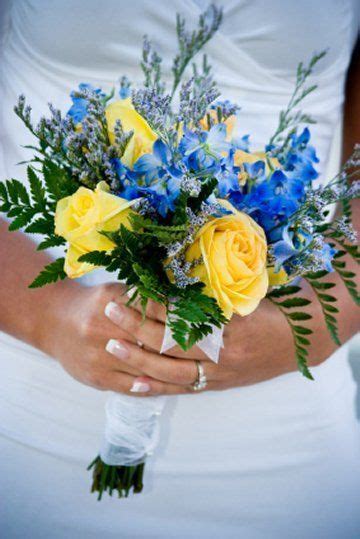 Bright Yellow Roses Contrast Beautifully With Bright Blue Delphinium