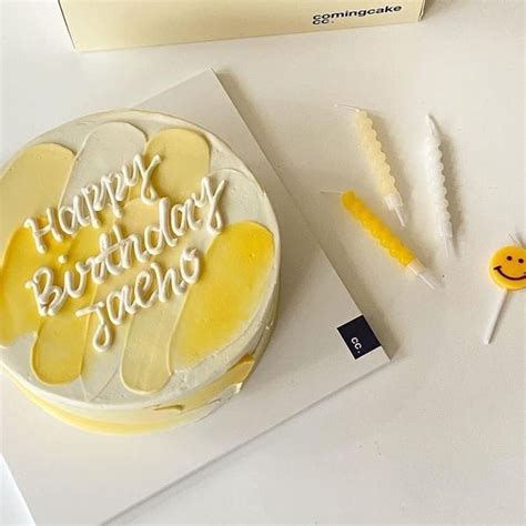 A Birthday Cake Sitting On Top Of A White Table Next To Some Yellow And