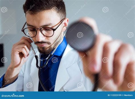 Concentrated Male Doctor Using the Stethoscope with His Patient. Stock ...