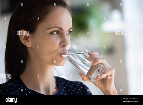 Close Up Attractive 20s Woman Holds Glass Drink Natural Water Stock