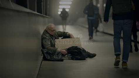 Elderly Homeless Man Suffering From Poverty Looking For Help At Train