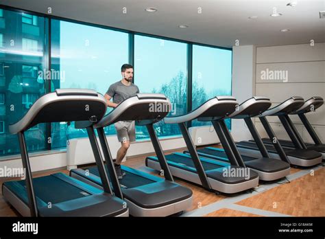 Handsome Man Running On The Treadmill In Gym Stock Photo Alamy