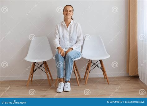 Image Of Smiling Satisfied Attractive Young Adult Woman Sitting On