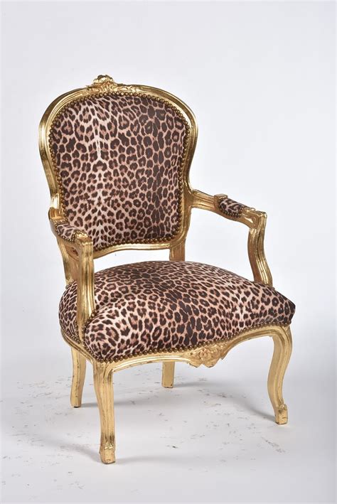 A Leopard Print Upholstered Chair With Gold Trim