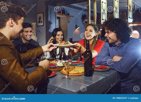 A Group Of Friends Eating At A Dinner In A Restaurant Stock Image