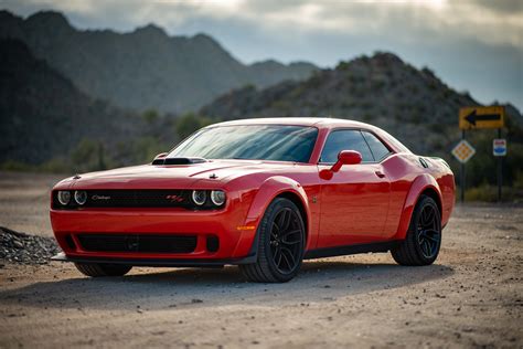 Red Dodge Challenger Parked on Unpaved Road · Free Stock Photo