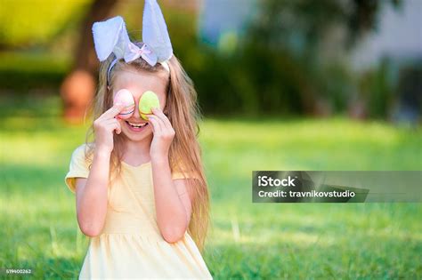 Adorable Girl Wearing Bunny Ears Holding Basket With Easter Eggs Stock