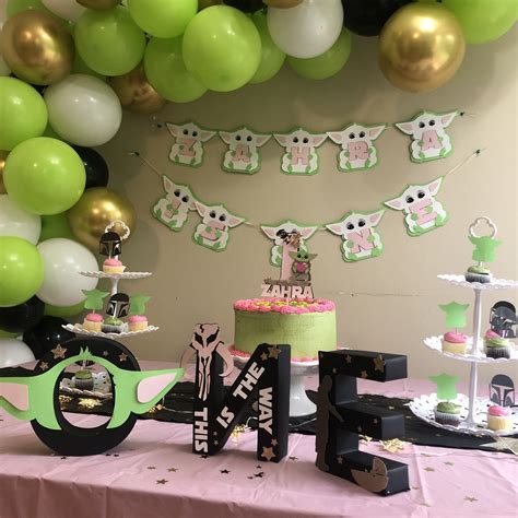 A Table Topped With A Cake And Balloons