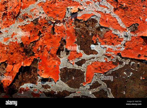 Orange White Coloured Paint Peeling Off A Rusted Metal Surface