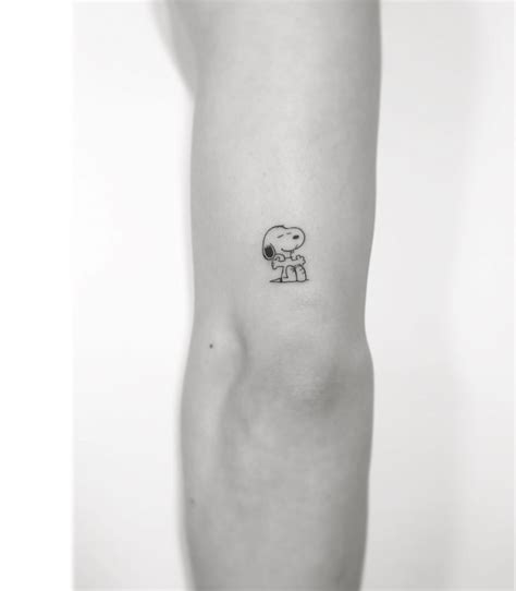 Small And Simple Snoopy Tattoo On The Back Of The Arm Tattoos Snoopy