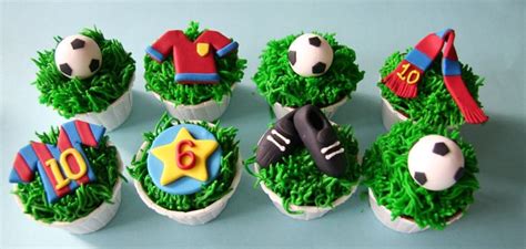 Cupcakes Made To Look Like Soccer Balls And Sports Gear Are On The Grass