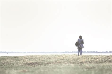 Premium Photo Rear View Of Woman Standing At Lakeshore Against Clear Sky