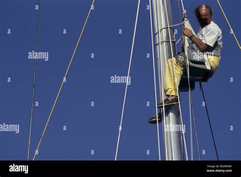 Man Climbing A Sailboat Mast Stock Photo Alamy