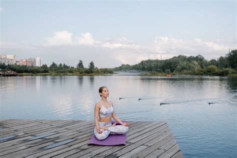 Woman Meditating On Pier By Stocksy Contributor Julia Volk Stocksy