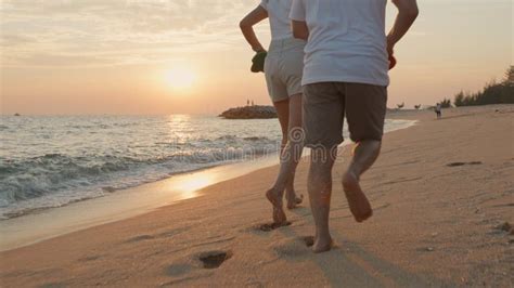 Vacation Loving Couple Running On Beach Together At Sunset Landscape