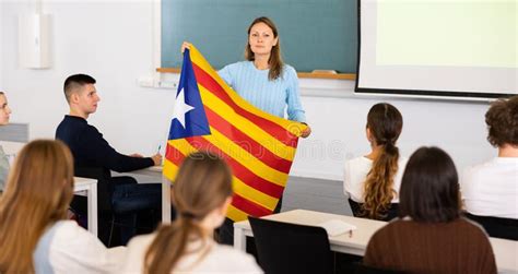 Geography Lesson in School Class - Teacher Talks about Catalonia, Holding Flag in His Hands ...