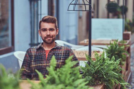 Portrait Of A Smiling Fashionable Bearded Male With A Stylish Haircut