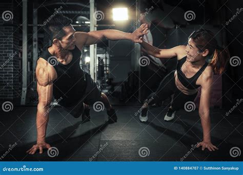 Young Sporty Couple Working Out Together At Gym Fitness Man And Woman