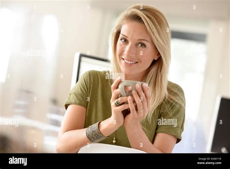 Attractive Blond Middle Aged Woman Dinking Hot Tea Stock Photo Alamy