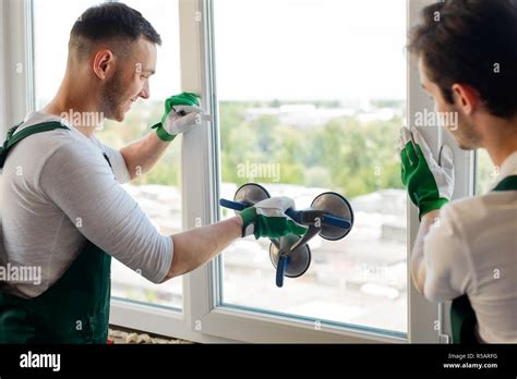 Men Are Replacing A Window Stock Photo Alamy