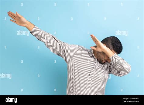 Portrait of anonymous businessman standing raised hands in dab dance ...