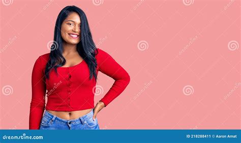 Hispanic Woman With Long Hair Wearing Casual Clothes Looking Positive