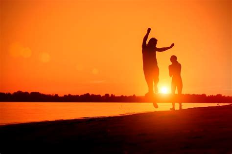 Premium Photo Naked Man And A Woman Running On The Beach At Sunset