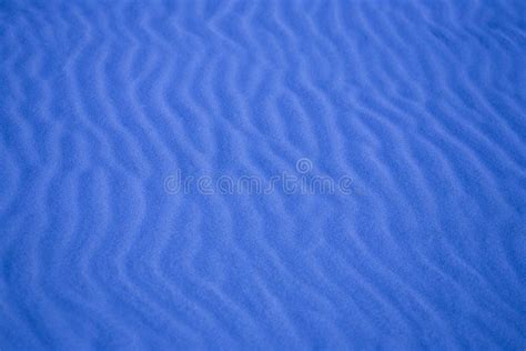 Blue Background With Sand In The Shape Of Sand Waves Stock Image